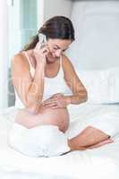 Pregnant woman having conversation on cellphone