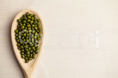 Wooden spoon of green lentils