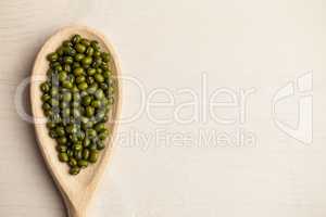 Wooden spoon of green lentils