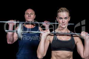 Portrait of muscular man and woman lifting crossfit
