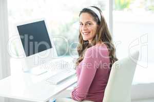 Portrait of happy businesswoman sitting on chair