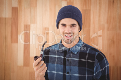 Portrait of hipster holding smoking pipe