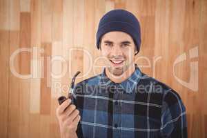 Portrait of hipster holding smoking pipe