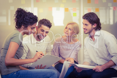 Businesswoman showing documents to colleagues