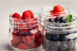 Glass jars of fresh berries