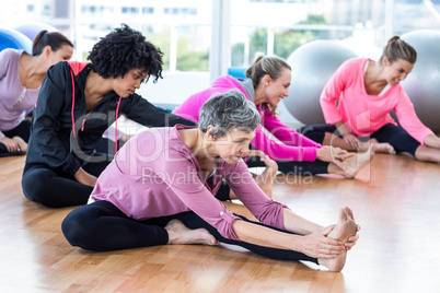 Fit women exercising on hardwood floor