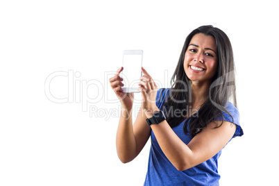 Smiling woman using a smartphoen and wearing a smartwatch