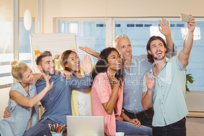 Business people taking selfie in meeting room