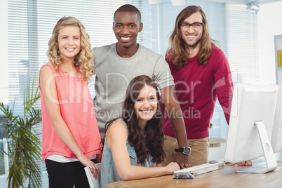 Portrait of happy business team working at computer desk