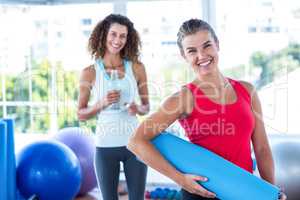 Portrait of happy women in fitness studio