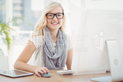 Portrait of smiling woman using computer