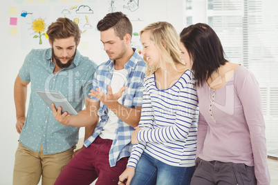 Man holding digital tablet gesturing