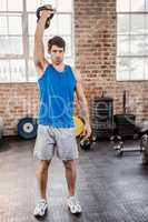 Portrait of muscular man holding kettlebell