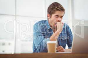 Tired businessman sitting at desk