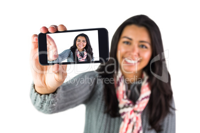 Smiling woman about to take a selfie