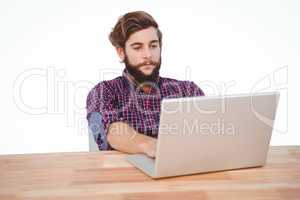Hipster working on laptop at desk