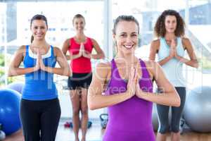 Fit women smiling with hands together