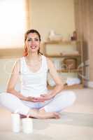 Full length portrait of smiling woman in yoga pose