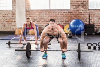 Two fit people working out