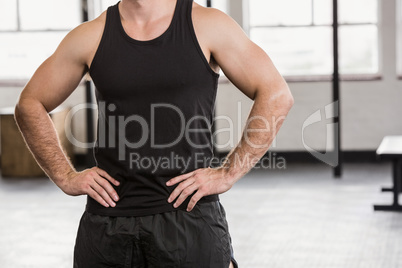 Midsection of man with hands on hip