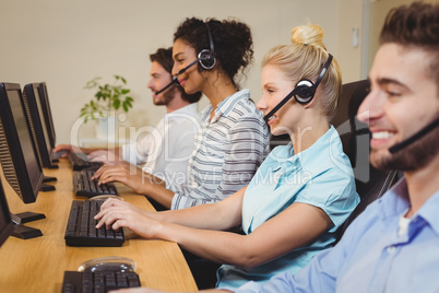 Smiling executives working in call center