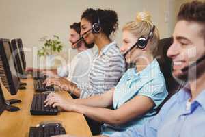 Smiling executives working in call center