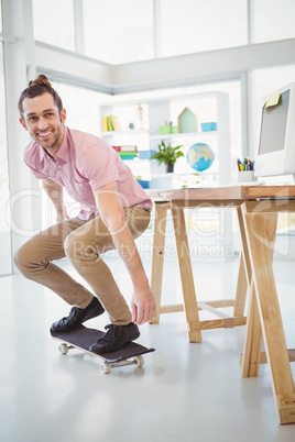 Businessman smiling while skateboarding