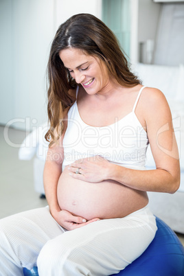 Happy woman looking at belly