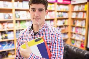 Confident young man with book