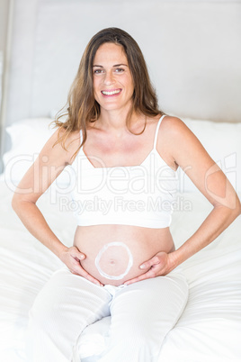 Portrait of circle moisturizer on pregnant belly