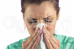Close-up of woman suffering from cold with tissue on mouth