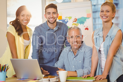 Happy business people using technologies in meeting room