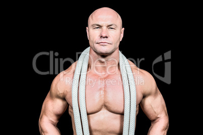 Portrait of confident fit man with rope around neck