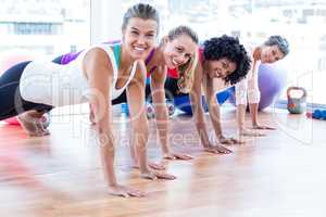 Portrait of smiling women exercising on floor
