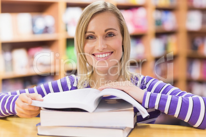 Young woman with book at desk