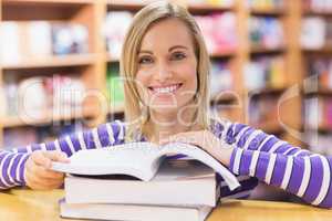 Young woman with book at desk