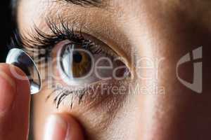 Woman about to insert her contact lens