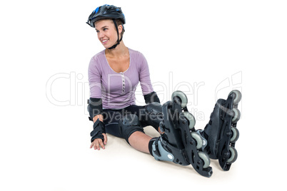 Sporty woman wearing inline skates relaxing