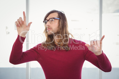 Creative businessman gesturing in office