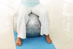 Pregnant woman sitting on exercise ball