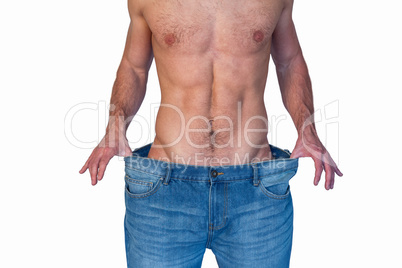Midsection of a man showing loose denim jeans