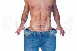 Midsection of a man showing loose denim jeans