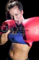 Portrait of aggressive female boxer with fighting stance