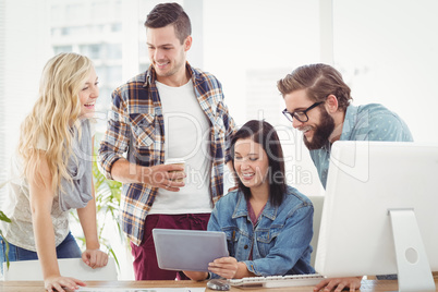 Smiling Business professionals using digital tablet