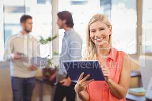 Smiling businesswoman using digital PC