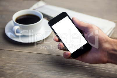 Person showing mobile phone at desk