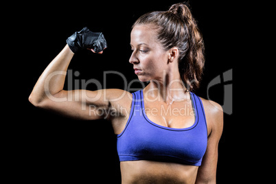 Confident woman flexing muscles