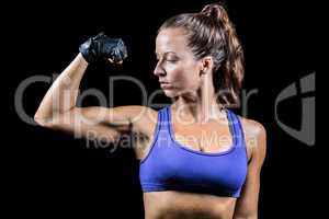 Confident woman flexing muscles