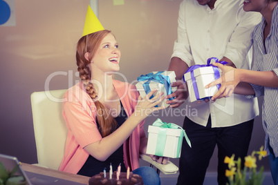 Happy businesswoman receiving birthday gifts