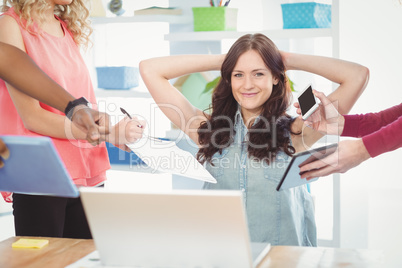 Portrait of smiling woman with hands behind head